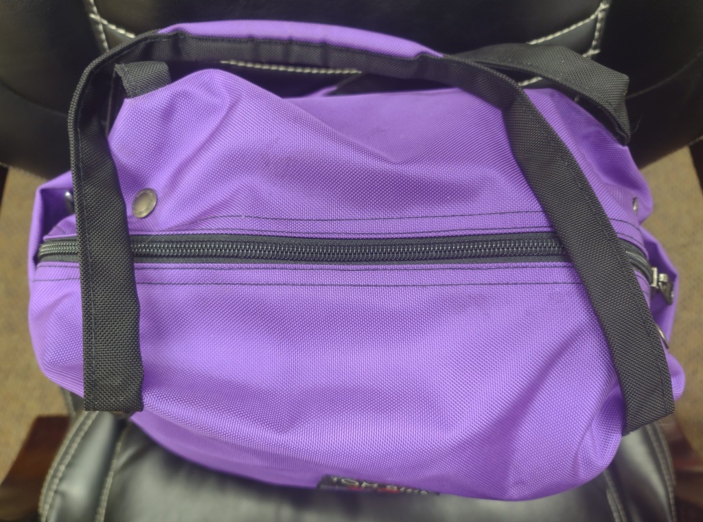 Zipped-up bright purple bag
